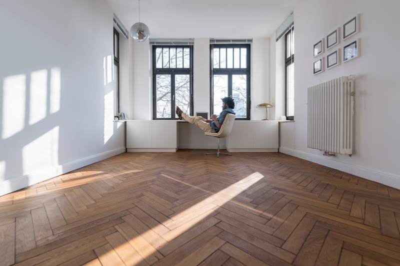Homeowner sits in an empty room admiring the square footage.