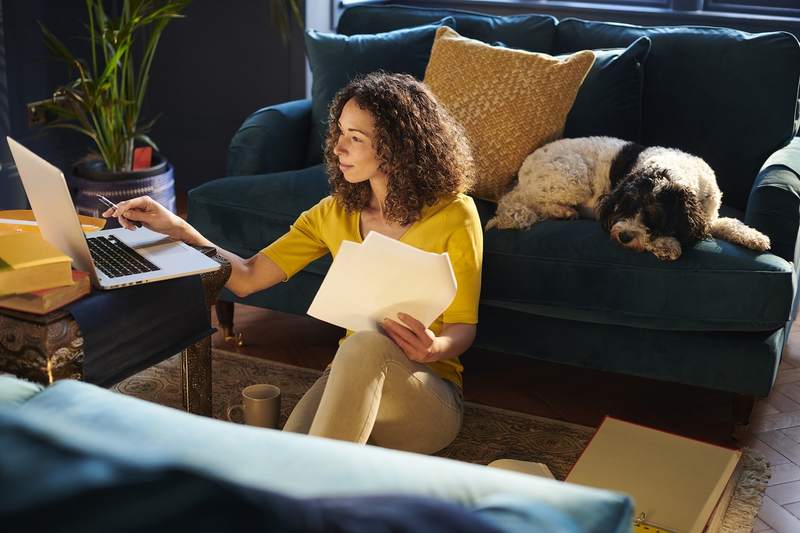 Homebuyer researching in her apartment about the pros and cons of a 30-year fixed-rate mortgage.