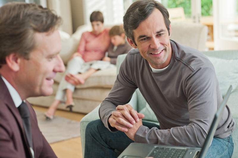 Family reviews mortgage documents with financial advisor.