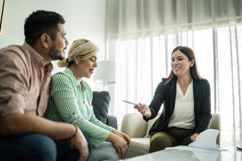 Couple discusses mortgage options with an agent.
