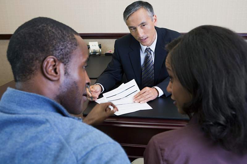 Couple discusses mortgage options with a lender.